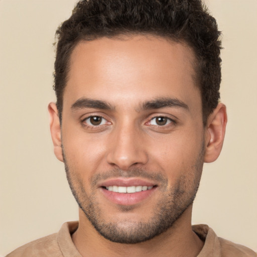 Joyful white young-adult male with short  brown hair and brown eyes