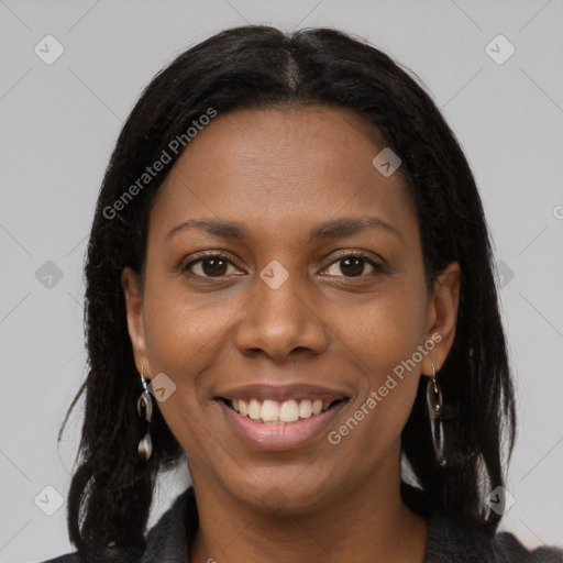 Joyful black young-adult female with long  brown hair and brown eyes