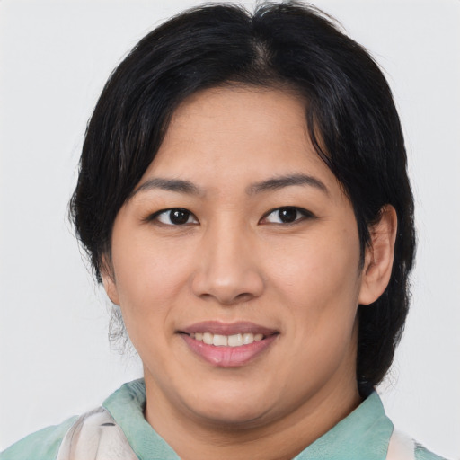 Joyful asian young-adult female with medium  brown hair and brown eyes