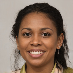 Joyful black young-adult female with medium  brown hair and brown eyes