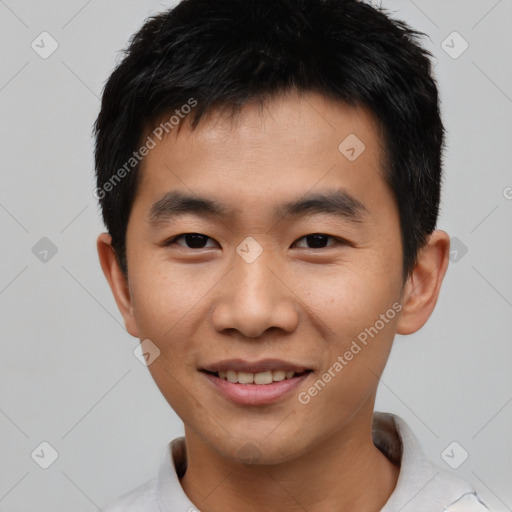 Joyful asian young-adult male with short  black hair and brown eyes