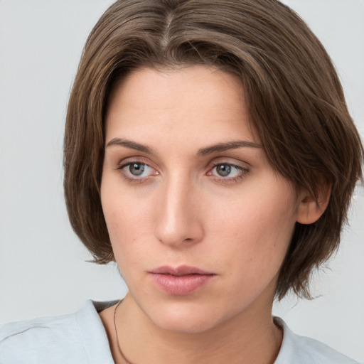 Neutral white young-adult female with medium  brown hair and green eyes