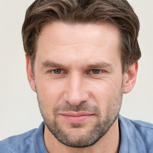 Joyful white adult male with short  brown hair and grey eyes