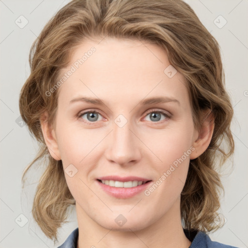 Joyful white young-adult female with medium  brown hair and blue eyes