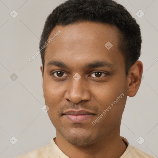 Joyful black young-adult male with short  brown hair and brown eyes