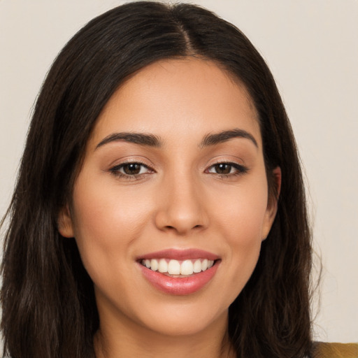 Joyful white young-adult female with long  brown hair and brown eyes