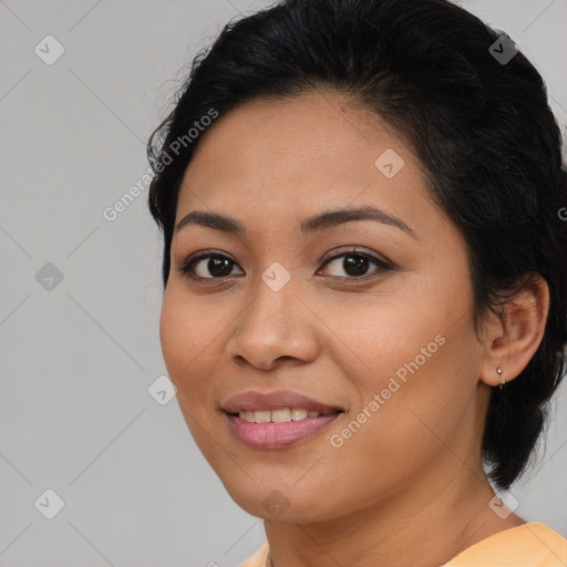 Joyful latino young-adult female with medium  brown hair and brown eyes