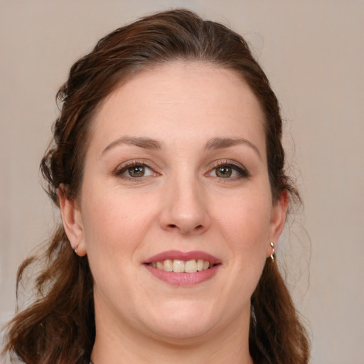 Joyful white young-adult female with medium  brown hair and blue eyes