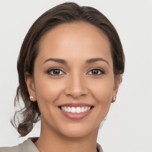 Joyful white young-adult female with medium  brown hair and brown eyes