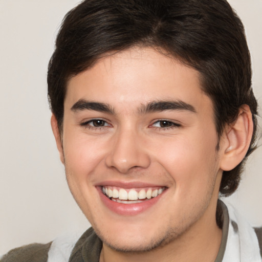 Joyful white young-adult male with medium  brown hair and brown eyes