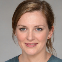 Joyful white young-adult female with medium  brown hair and blue eyes