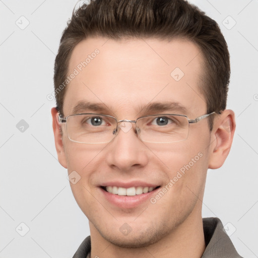 Joyful white young-adult male with short  brown hair and grey eyes