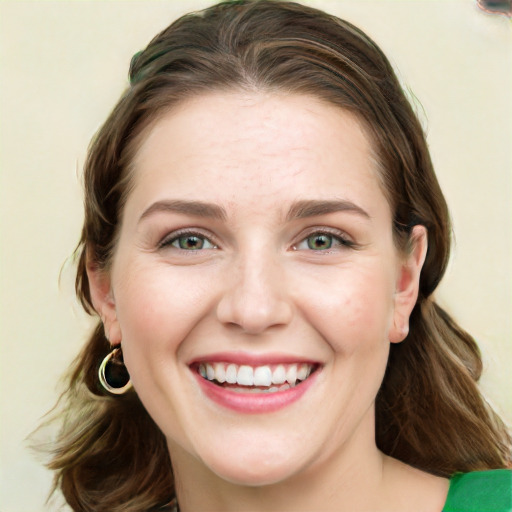 Joyful white young-adult female with medium  brown hair and green eyes