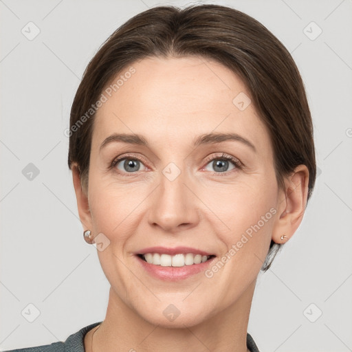 Joyful white young-adult female with short  brown hair and grey eyes