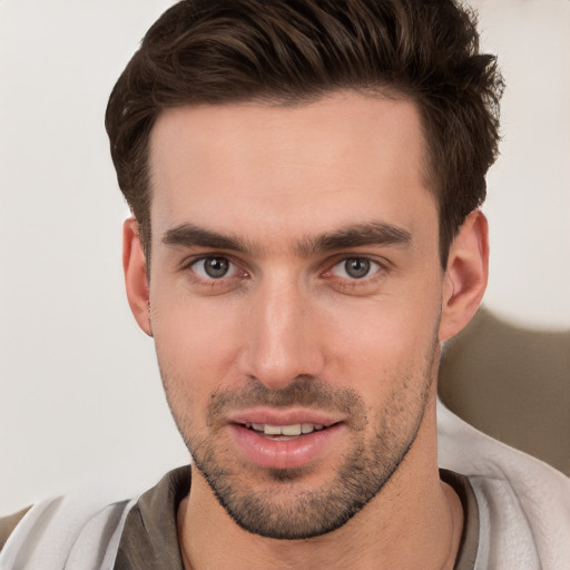 Joyful white young-adult male with short  brown hair and brown eyes