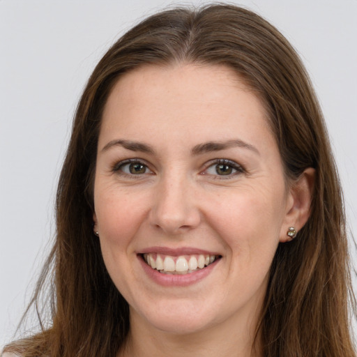 Joyful white young-adult female with long  brown hair and grey eyes