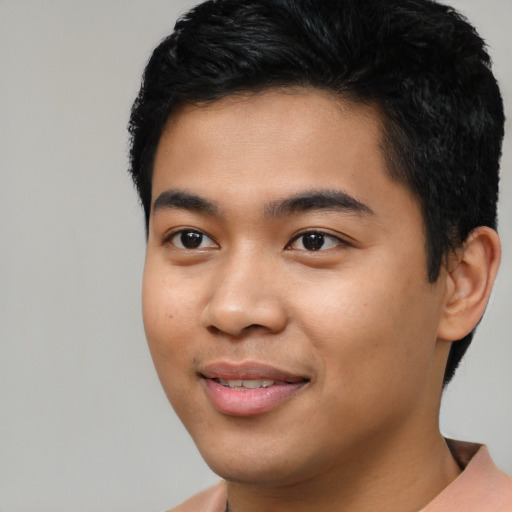 Joyful asian young-adult male with short  black hair and brown eyes