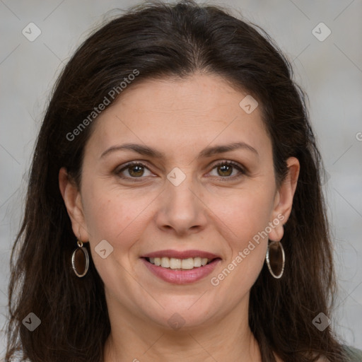 Joyful white adult female with long  brown hair and grey eyes