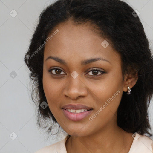 Joyful black young-adult female with long  brown hair and brown eyes