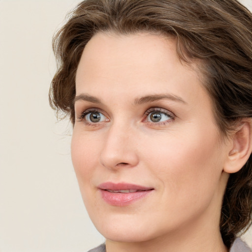 Joyful white young-adult female with medium  brown hair and blue eyes