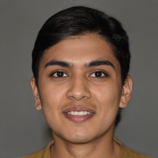 Joyful latino young-adult male with short  brown hair and brown eyes