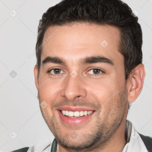 Joyful white young-adult male with short  brown hair and brown eyes