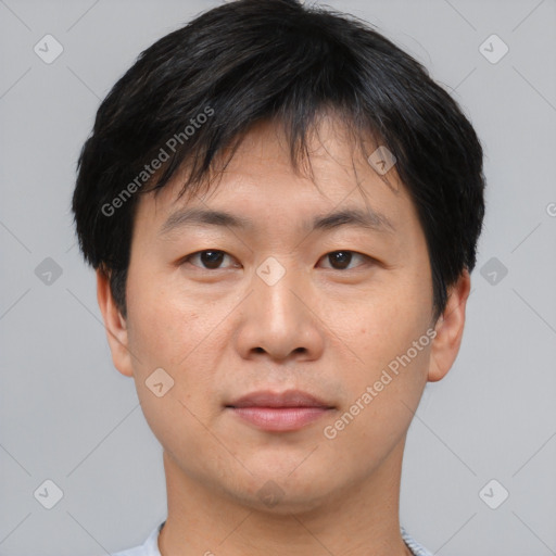 Joyful asian young-adult male with short  brown hair and brown eyes