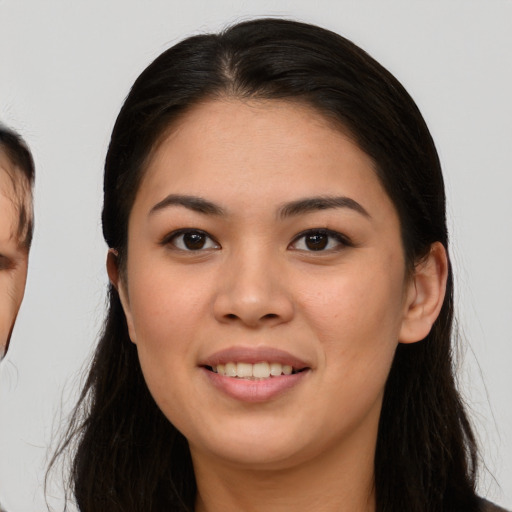 Joyful asian young-adult female with long  brown hair and brown eyes