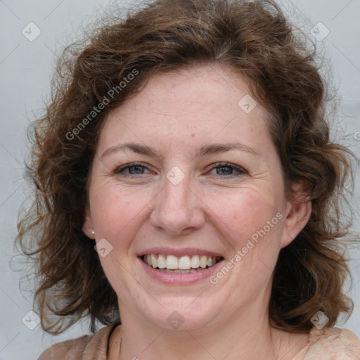 Joyful white adult female with medium  brown hair and blue eyes