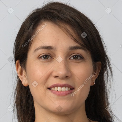 Joyful white young-adult female with long  brown hair and brown eyes