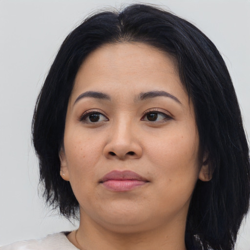 Joyful asian young-adult female with medium  black hair and brown eyes