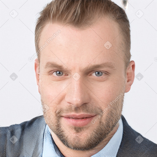 Joyful white adult male with short  brown hair and blue eyes