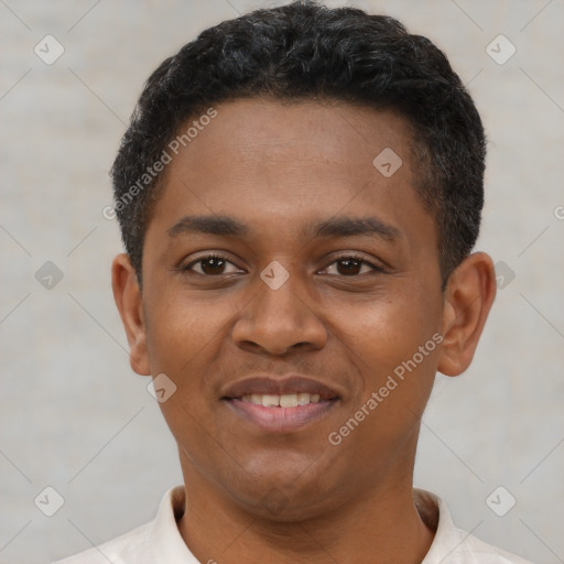 Joyful latino young-adult male with short  black hair and brown eyes