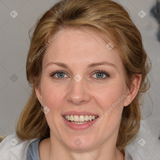 Joyful white adult female with medium  brown hair and blue eyes