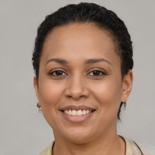 Joyful latino young-adult female with short  brown hair and brown eyes
