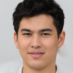 Joyful asian young-adult male with short  brown hair and brown eyes