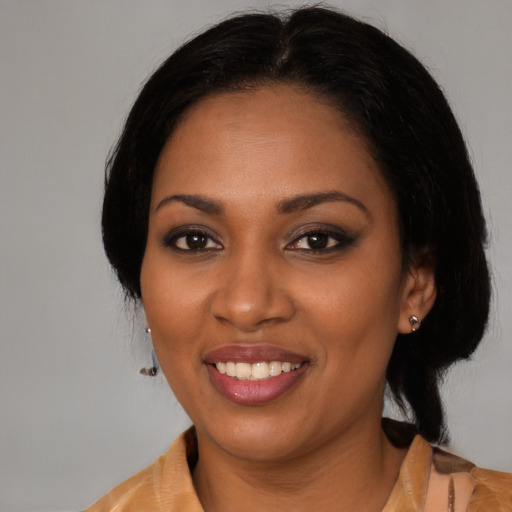 Joyful black young-adult female with medium  black hair and brown eyes