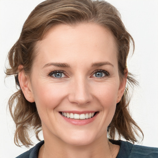 Joyful white young-adult female with medium  brown hair and blue eyes