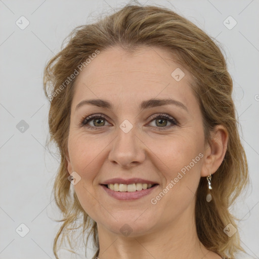 Joyful white adult female with medium  brown hair and green eyes