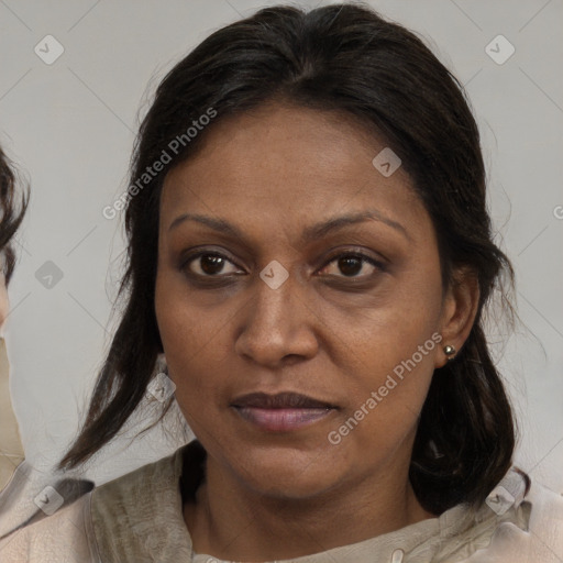 Joyful black adult female with medium  brown hair and brown eyes