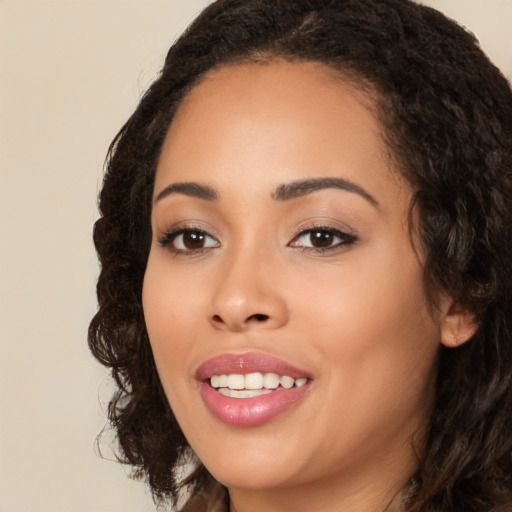 Joyful latino young-adult female with long  brown hair and brown eyes