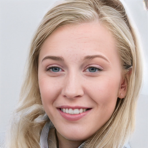 Joyful white young-adult female with long  brown hair and blue eyes