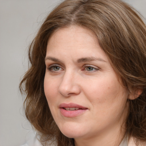 Joyful white adult female with medium  brown hair and grey eyes