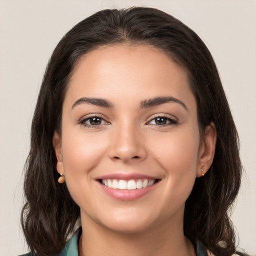 Joyful white young-adult female with long  brown hair and brown eyes