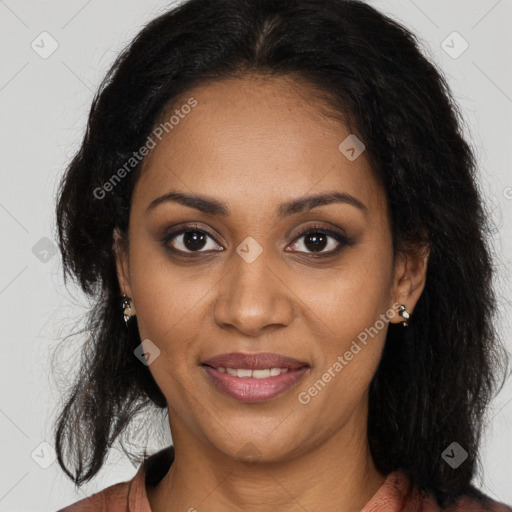 Joyful black young-adult female with long  brown hair and brown eyes