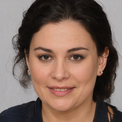 Joyful white adult female with medium  brown hair and brown eyes