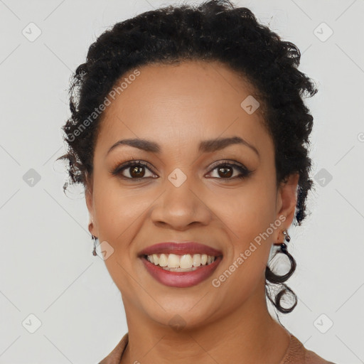 Joyful black young-adult female with short  black hair and brown eyes