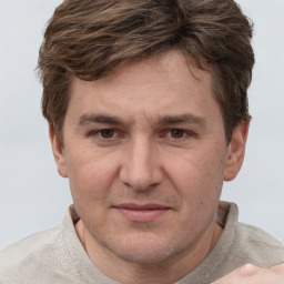 Joyful white adult male with short  brown hair and grey eyes