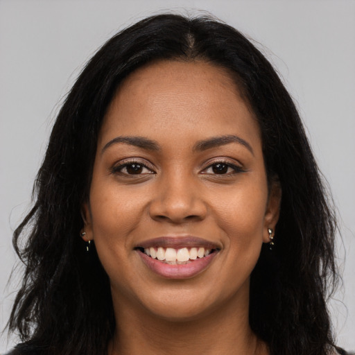 Joyful latino young-adult female with long  brown hair and brown eyes