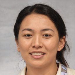 Joyful asian young-adult female with medium  brown hair and brown eyes